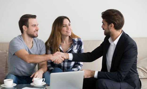 A landloard shaking new tenants hards after successfully screening them - Express Capital Financing