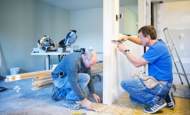 Two tradesmen working on a fix and flip investment property - ECF