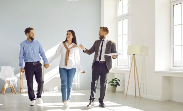 A landlord showing prospective tenants around a bright rental property - Express Capital Financing
