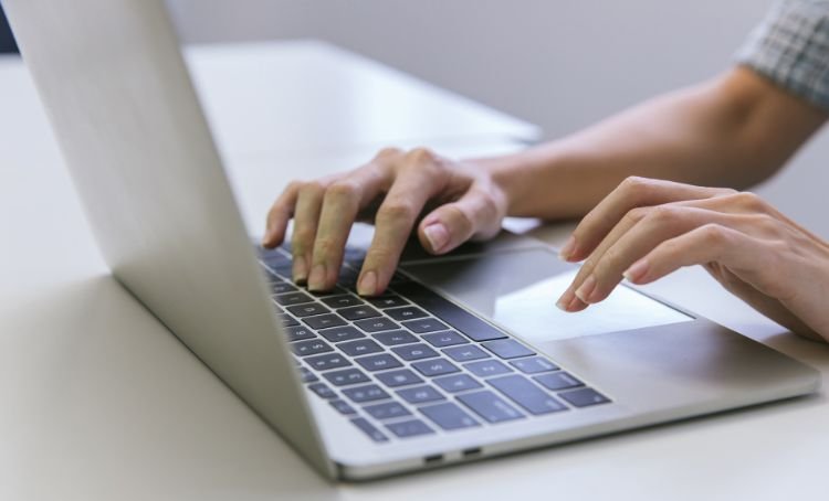 A property investor researching the rental marketing on a laptop - ECF