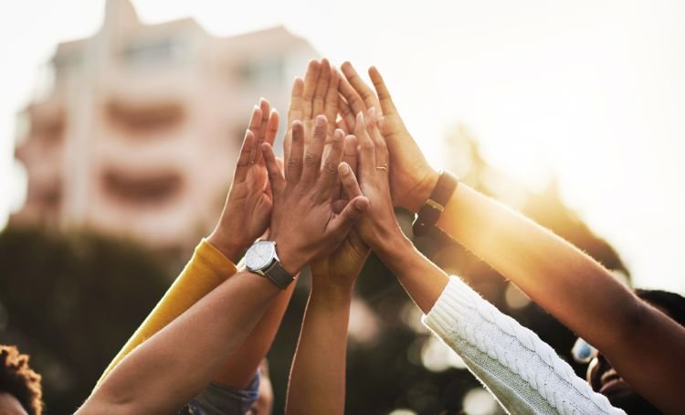 A group of successful house flippers high fiving - ECF