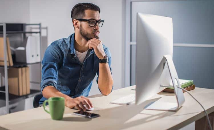 A property investor at a computer calculating their DSCR loan - Express Capital Financing