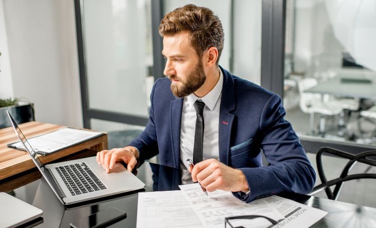 A property investor at a computer calculating the finances for their DSCR loan - Express Capital Financing