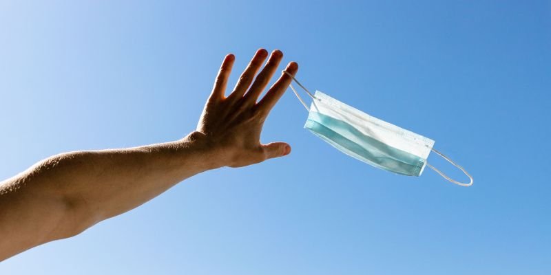 A person throwing a PPE mask away - Multifamily market post covid - ECF