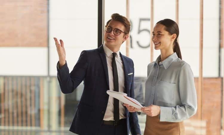 Property Investor and an estate agent viewing a property - FED Rate Cuts - Express Capital Financing