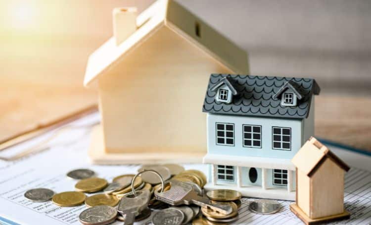Blueprints new build property with cash and keys on it - Financing a New Home Build - ECF