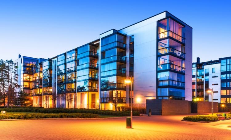 A modern office block with a lit carpark in front of it - Express Capital Financing