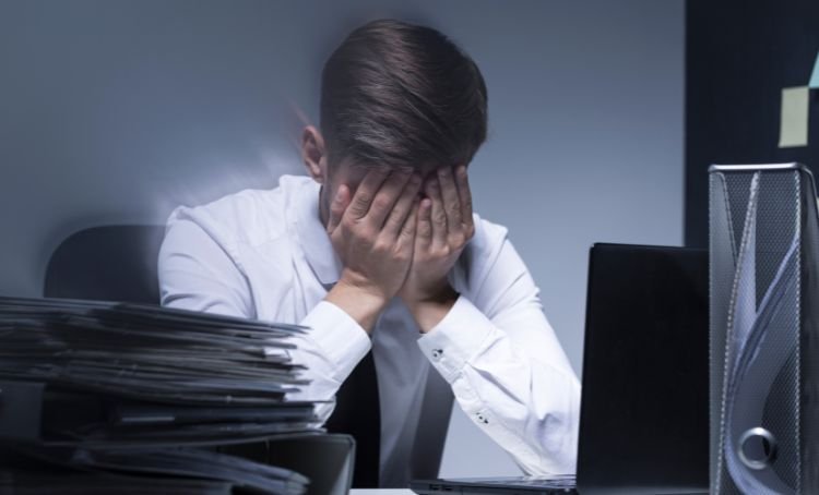 A property investor with his head in his hands - Multi family lending mistakes - ECF