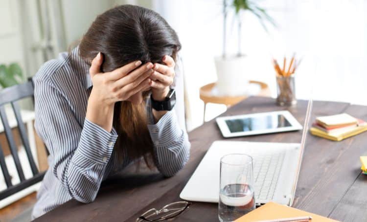 A property investor with her head in her hands - Multi family lending mistakes - ECF