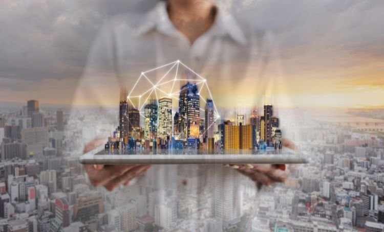 A real estate investor holding a table with a projection of a city - real estate technology - Express Capital Financing