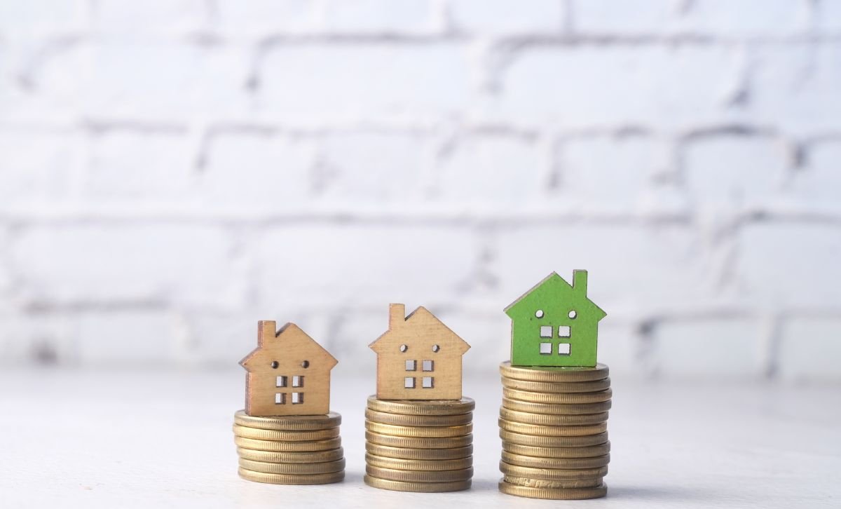 Three small top houses on piles of coins - Best time to sell property - Express Capital Financing