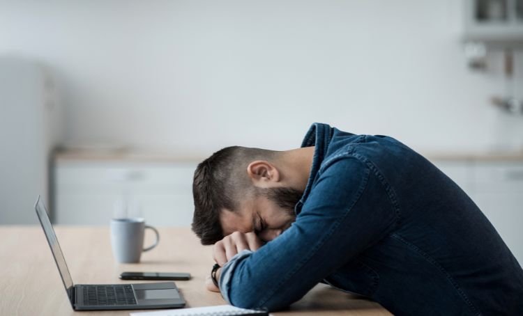 man with head in his hands - common financing mistakes