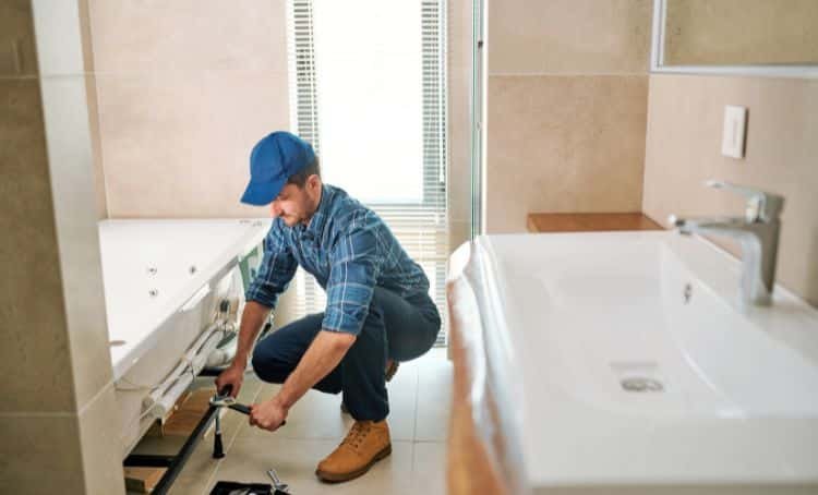 a man fixing a bathroom - fix and flip