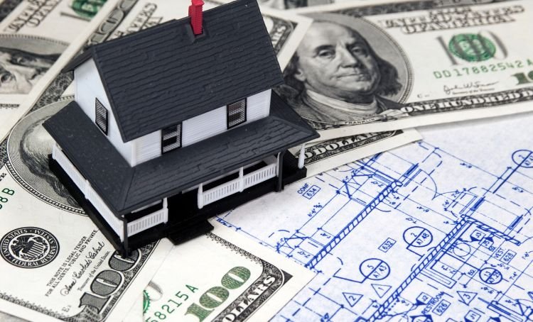 a small house on dollar bills - fix and flip