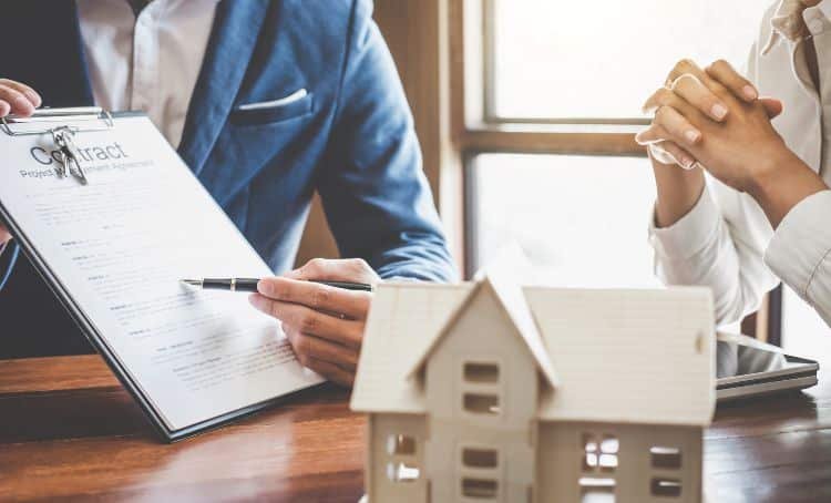 a pen pointing at a contract - hard money lender
